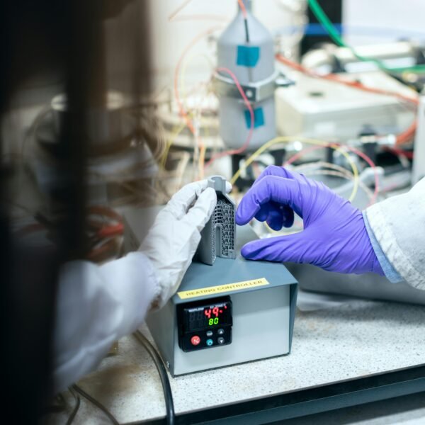 Scientist testing materials in a laboratory setting for clean energy solutions.