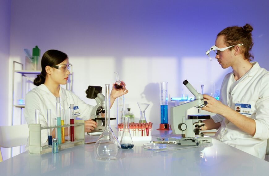 Two scientists working in a well-equipped laboratory conducting chemical research and experiments.