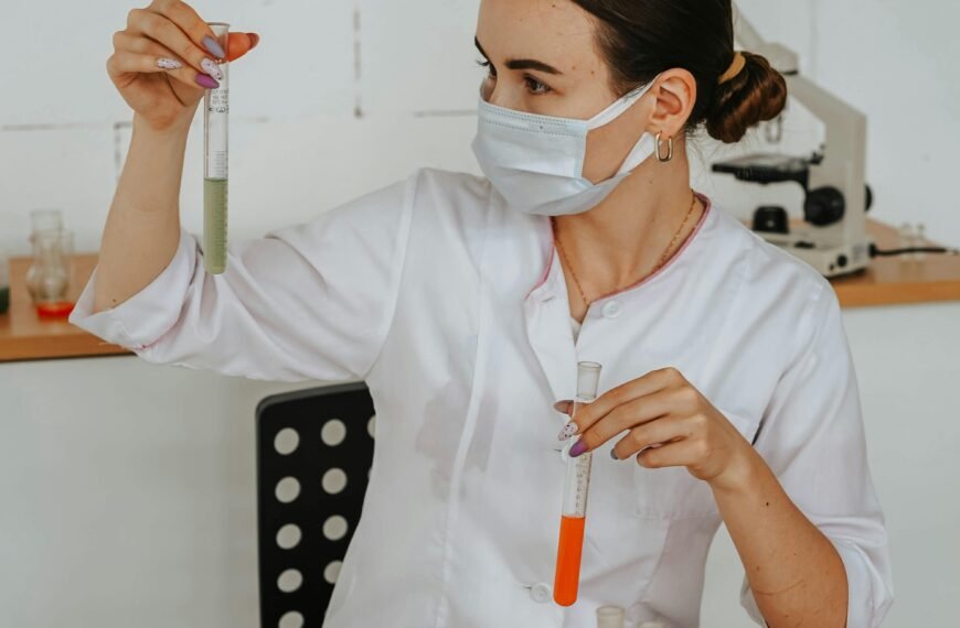 A female scientist carefully examines test tubes in a laboratory setting, showcasing scientific research and discovery.